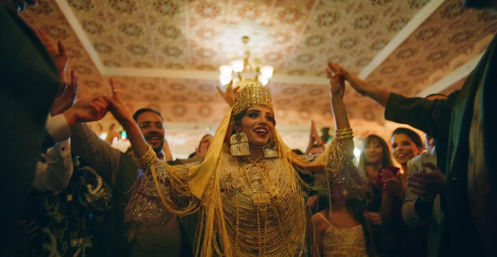 a woman dressed in a golden outfit surrounded by people