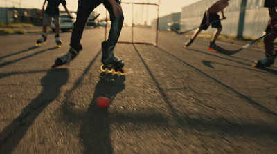 a group of people riding skateboards down a street