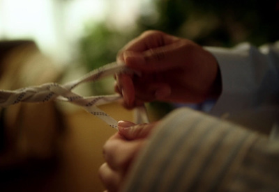 a close up of a person tying a rope