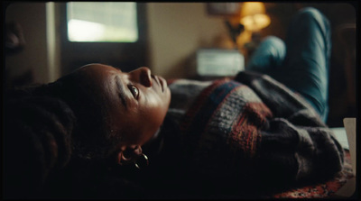 a young girl laying on a bed looking up