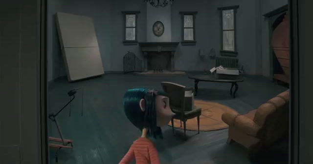 a girl looking at a chair in a room