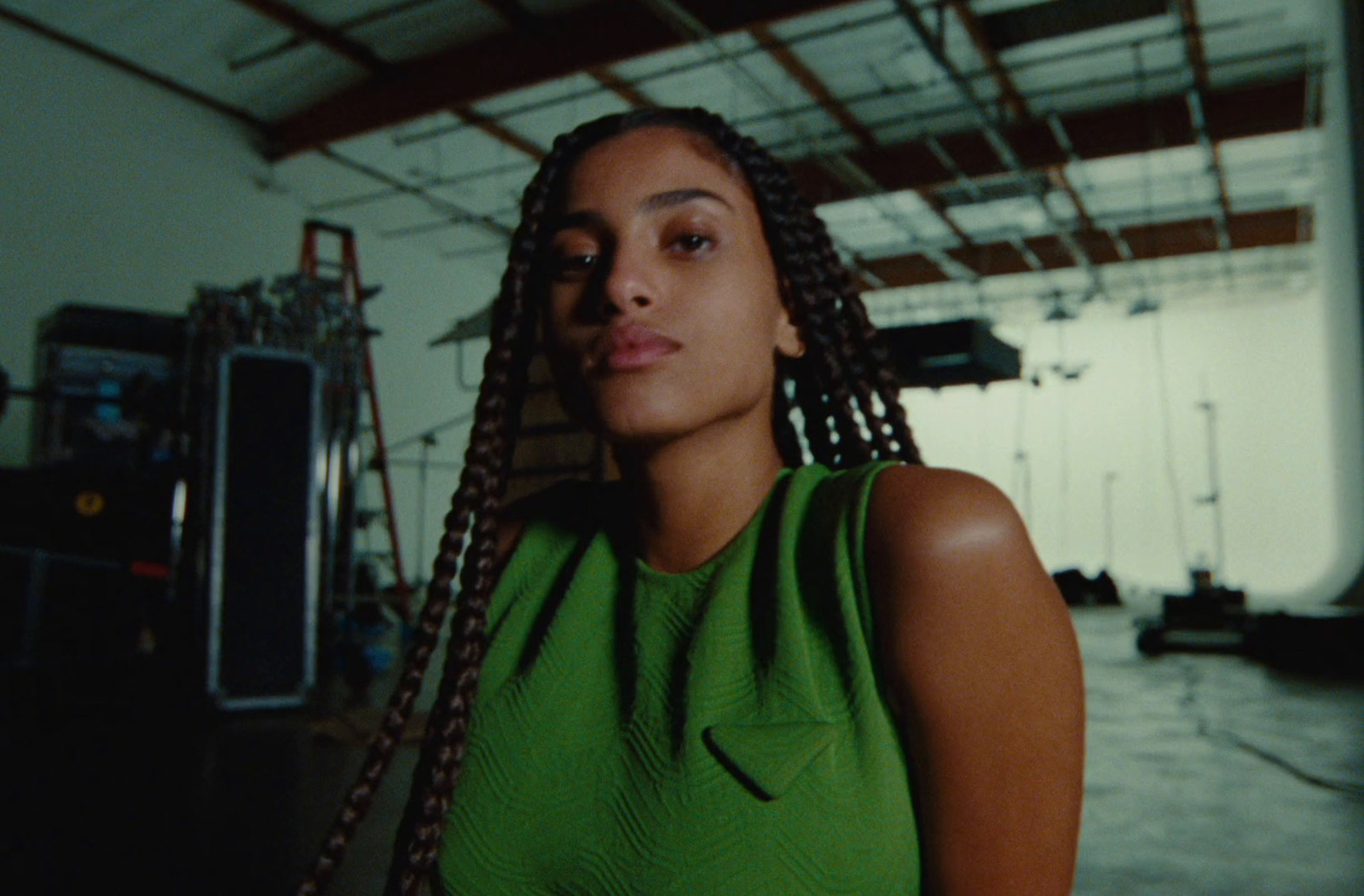 a woman in a green dress standing in a room