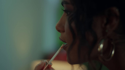 a woman brushing her teeth with a toothbrush