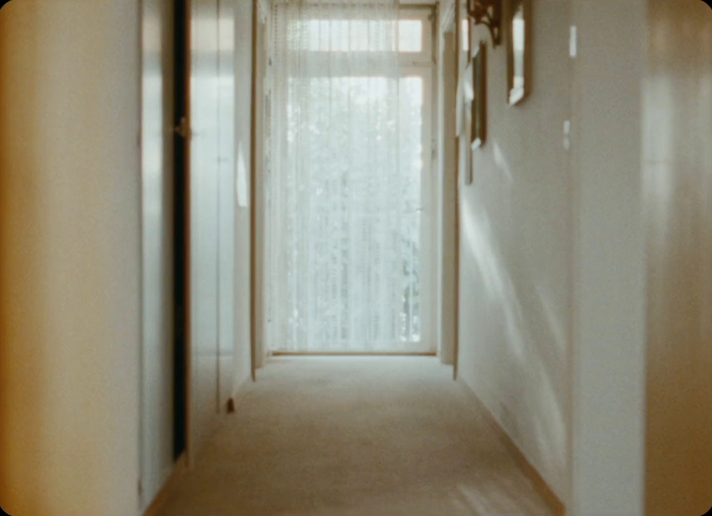 a long hallway with a clock on the wall