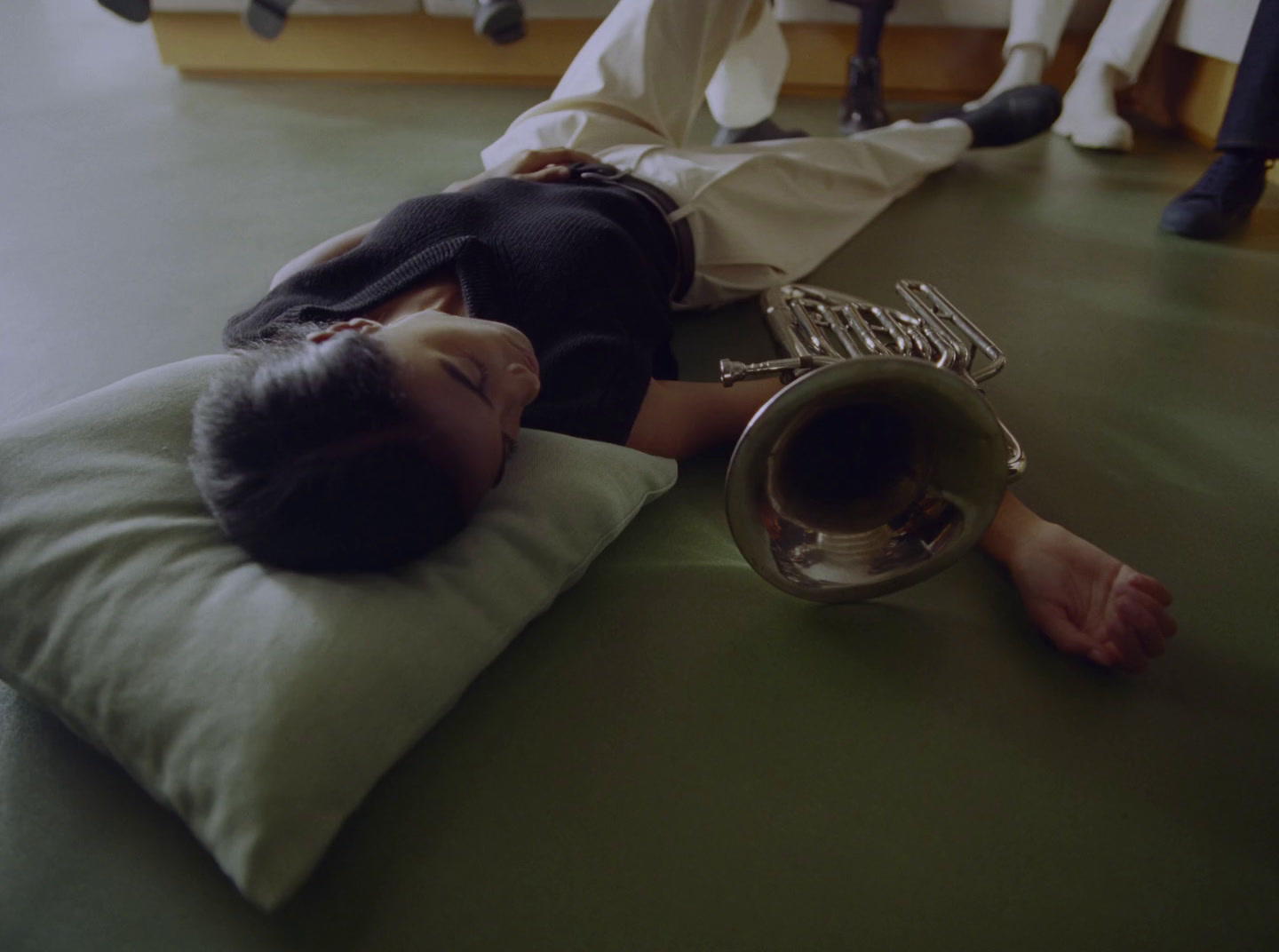 a woman laying on a pillow on the floor