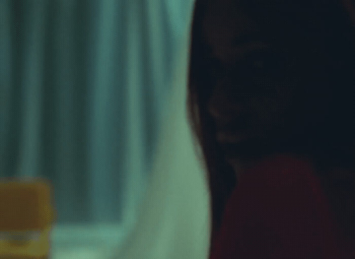 a blurry photo of a woman's face in front of a window