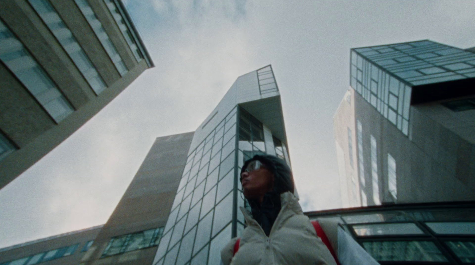 a woman standing in front of a tall building