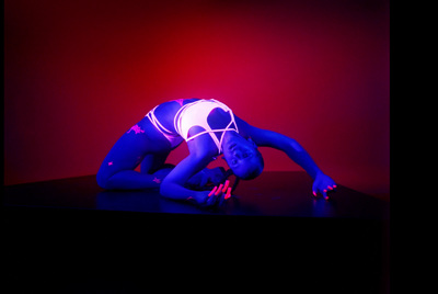 a woman in a neon blue and white leotard