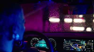 a man driving a car in the dark