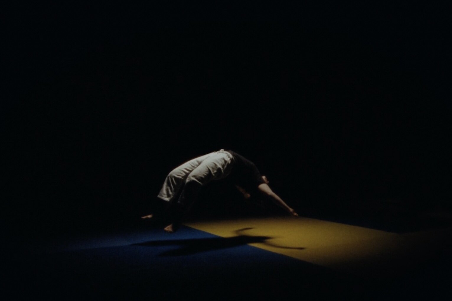 a man is doing a handstand in the dark