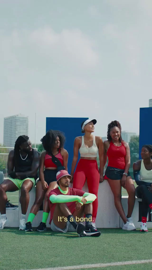 a group of women sitting next to each other on a field