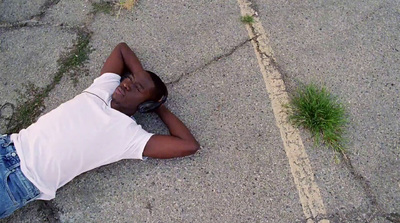 a man laying on the ground with his head in his hands