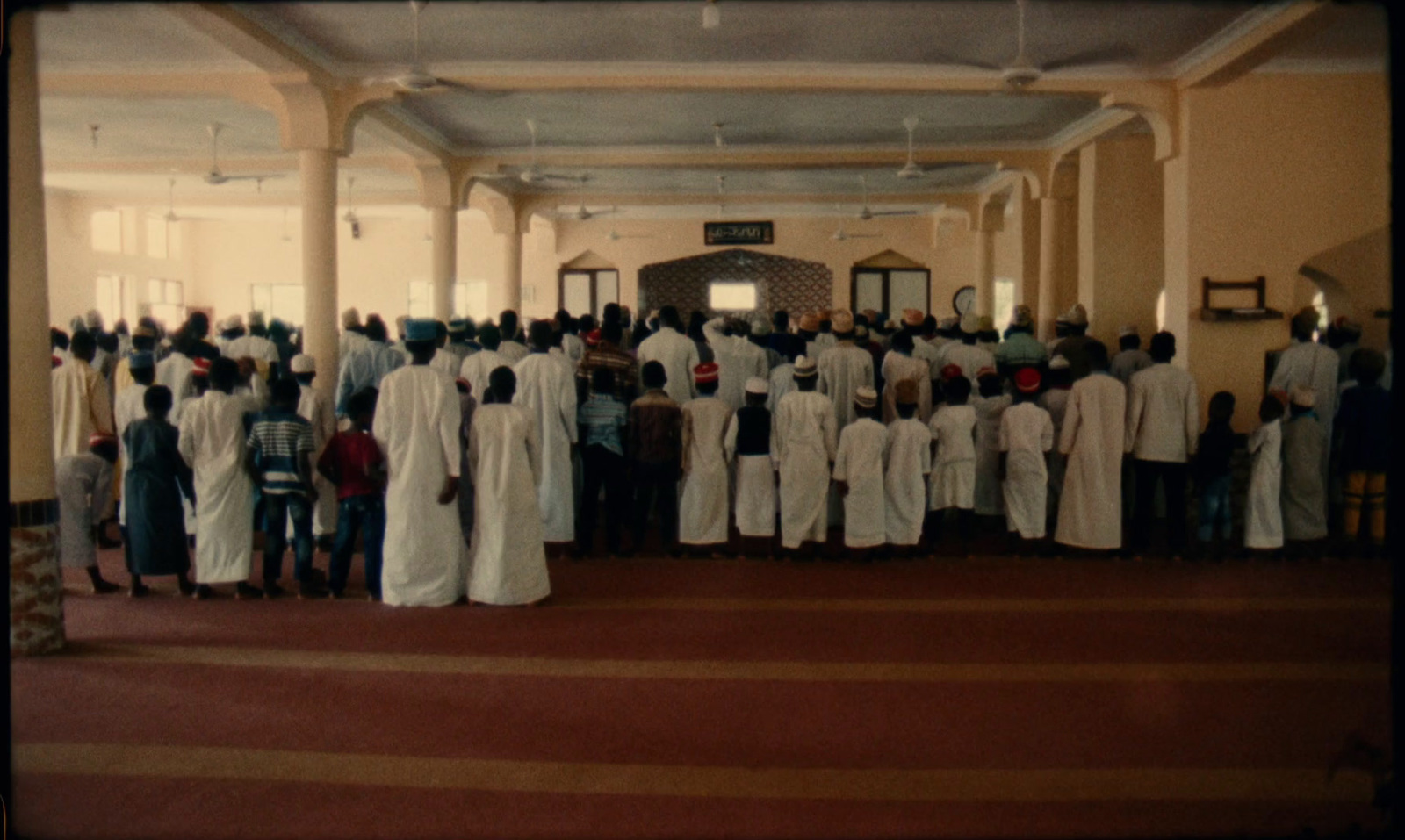 a large group of people standing in a room