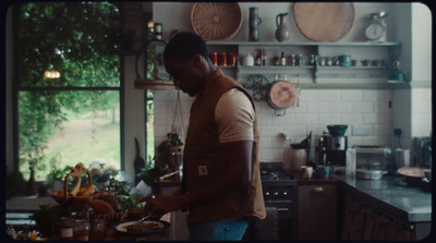 a man standing in a kitchen preparing food