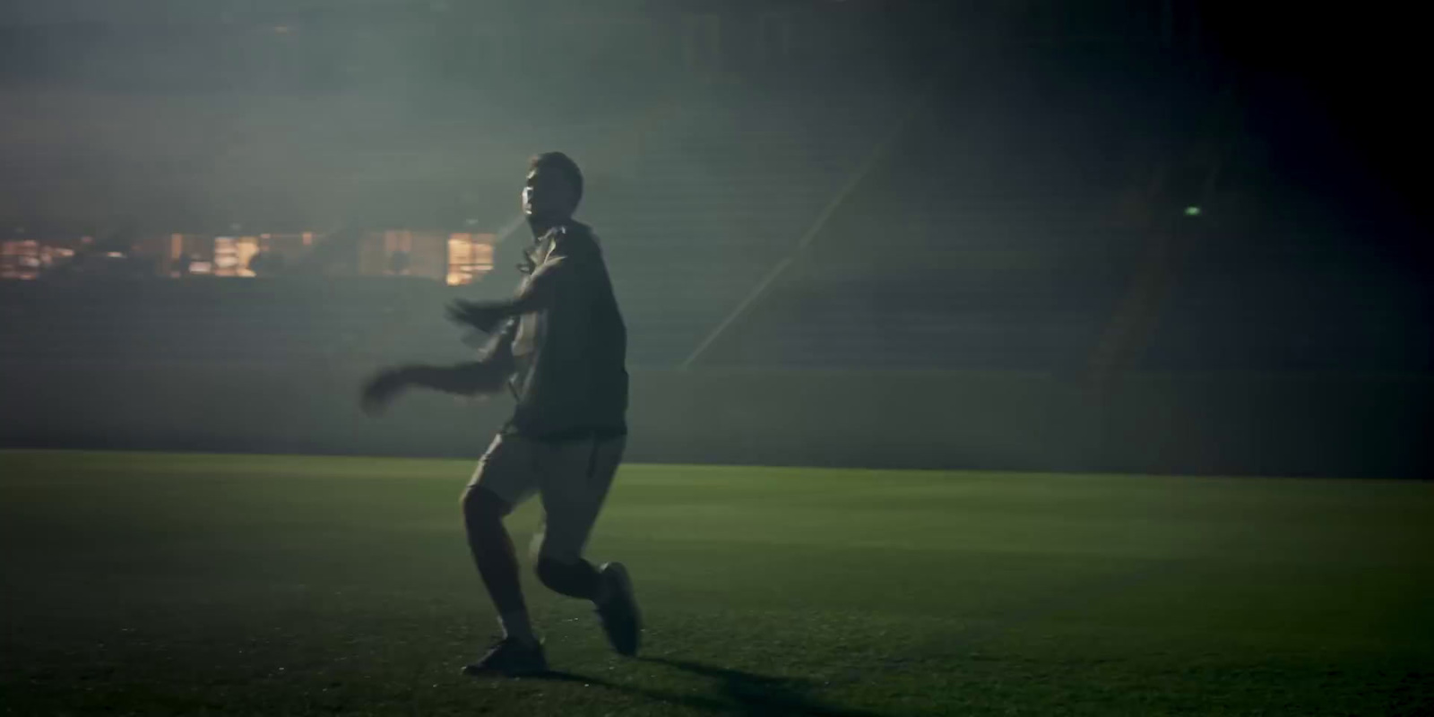 a man running across a field at night