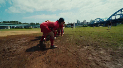 a group of people standing on top of a dirt field