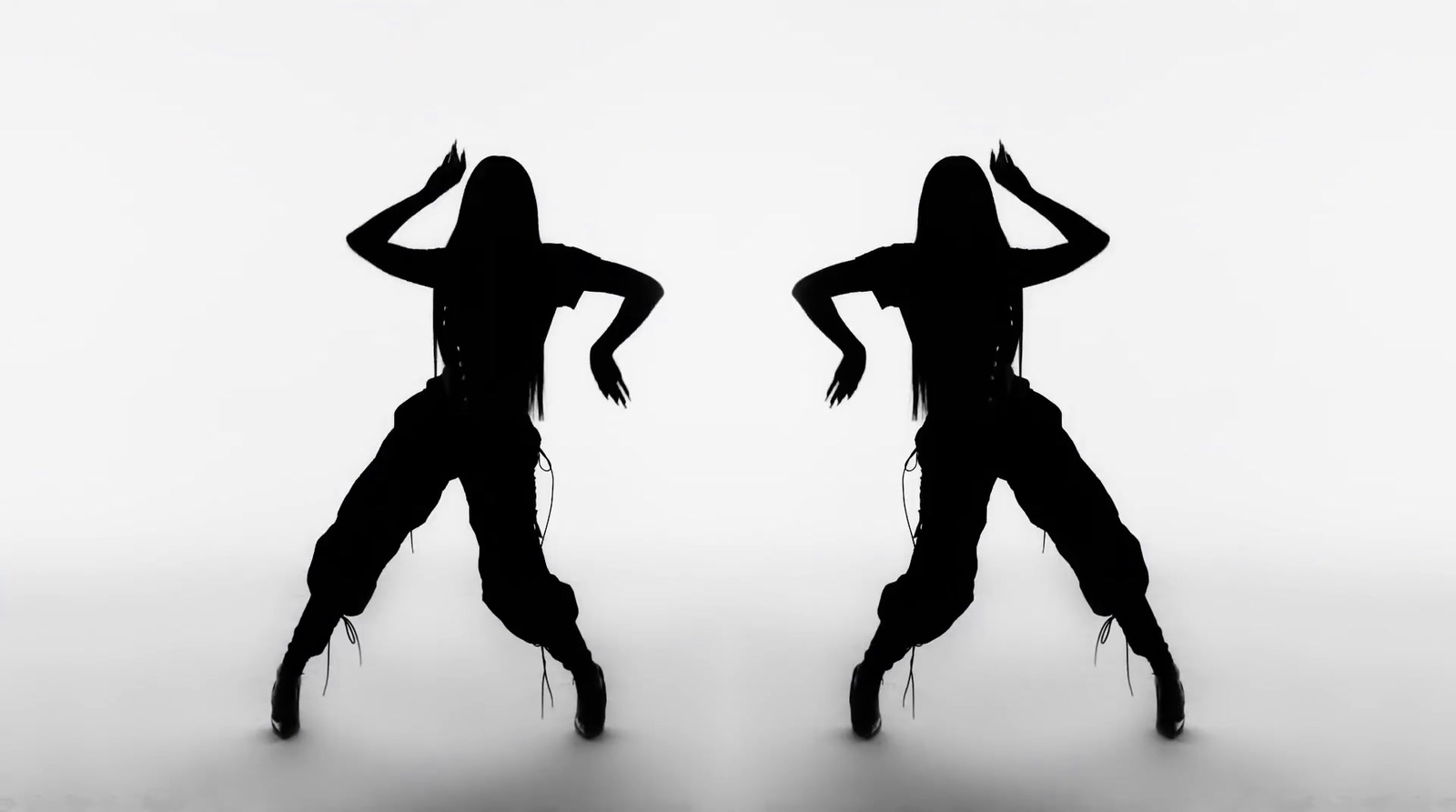 two silhouettes of a woman dancing on a white background