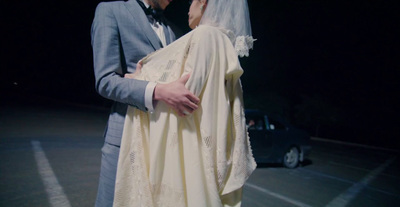 a man and a woman dressed in wedding attire