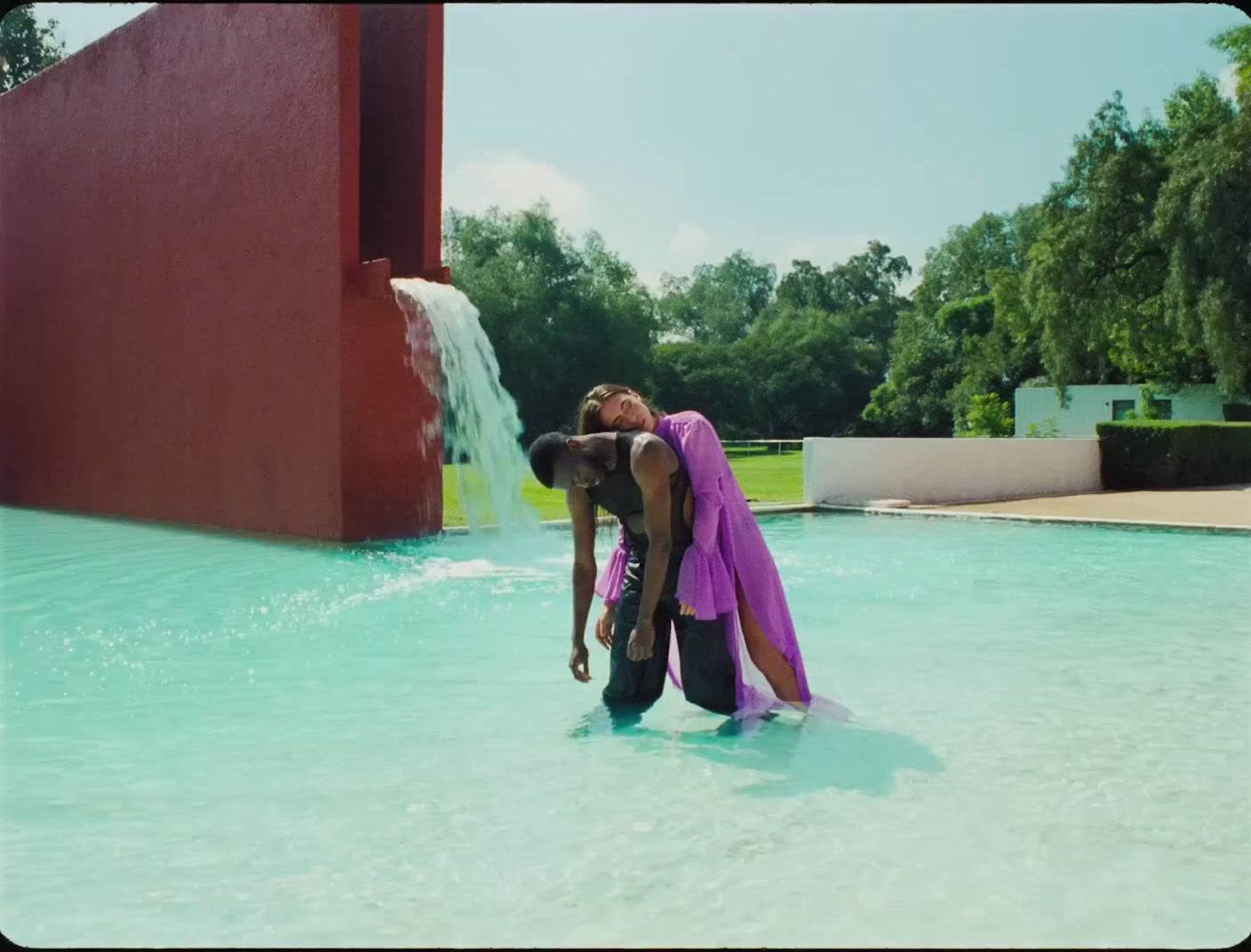 a man and a woman standing in a pool of water