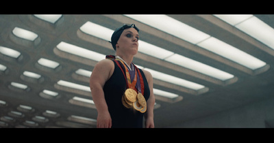 a woman wearing a medal standing in a room