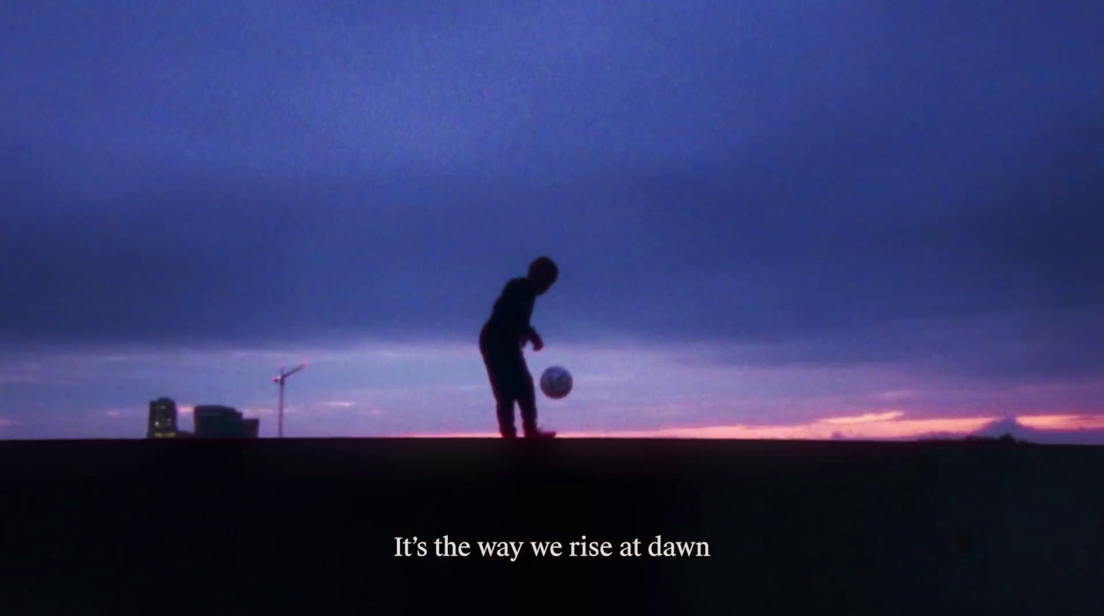 a man standing on top of a field holding a soccer ball