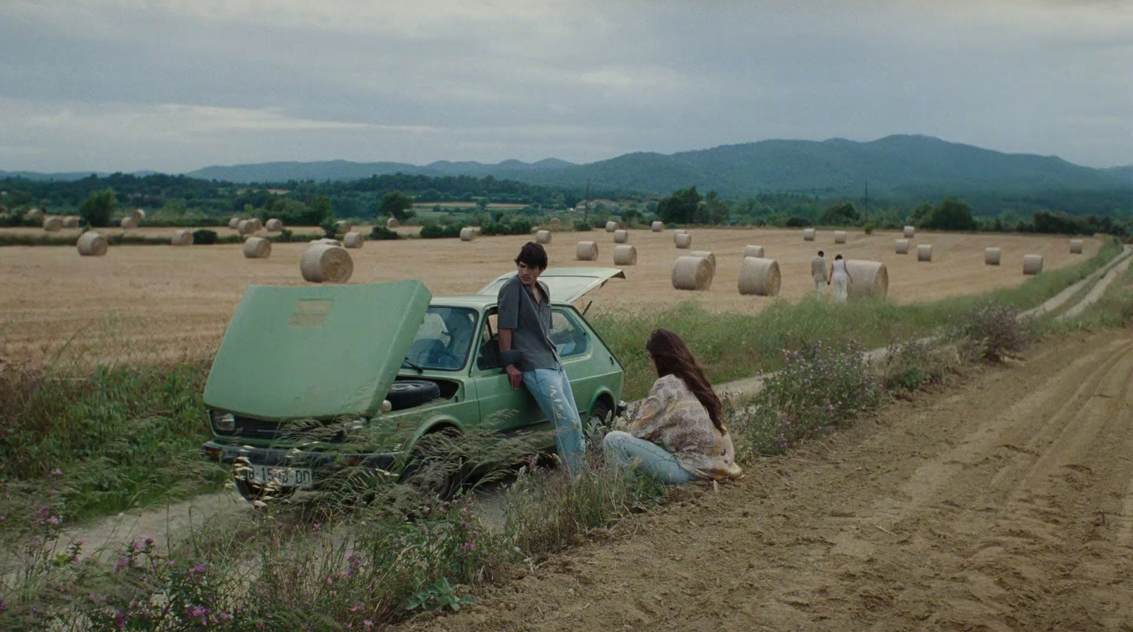 a couple of people standing next to a truck