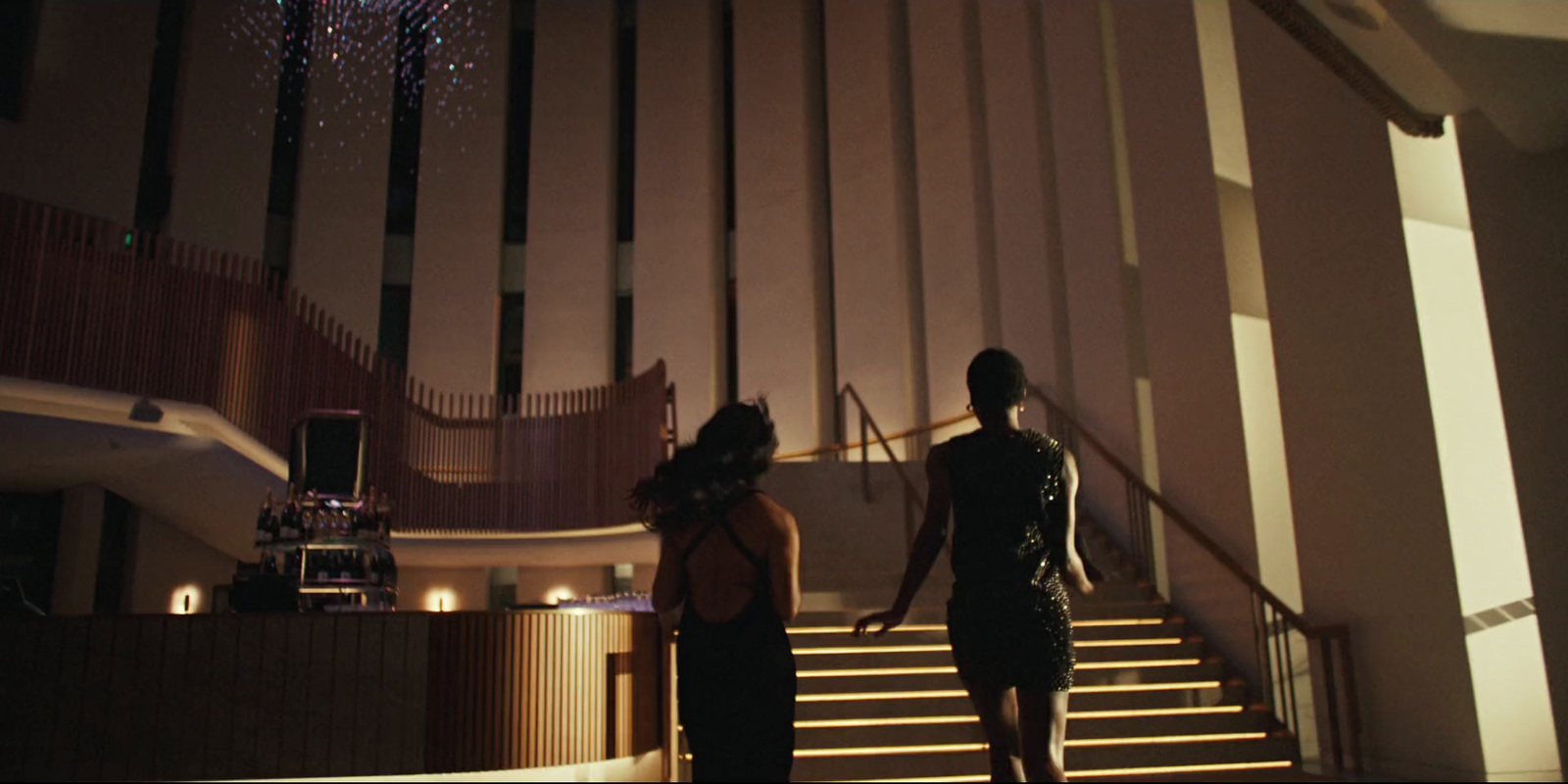 a couple of women standing on top of a set of stairs