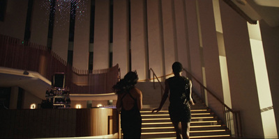 a couple of women standing on top of a set of stairs