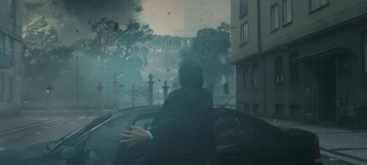 a man standing next to a car on a city street