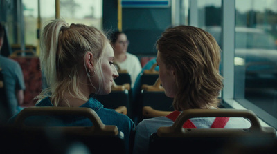 a couple of women sitting next to each other on a bus