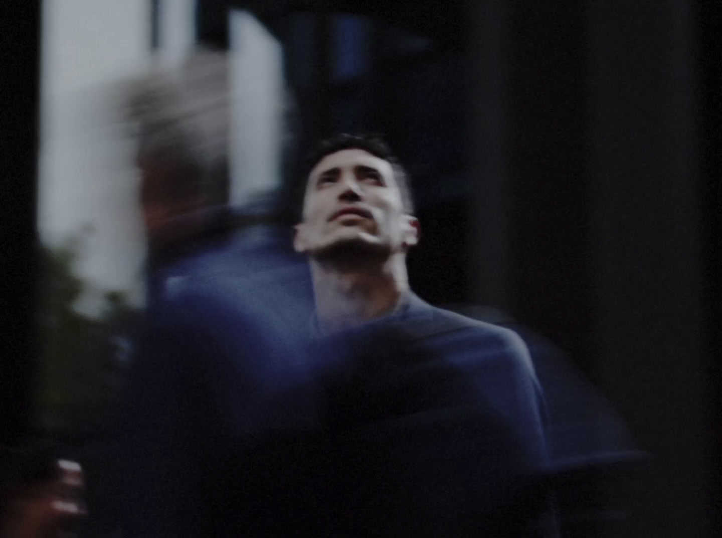 a man standing in front of a tall building