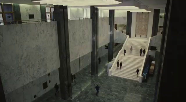 a group of people walking up and down stairs in a building