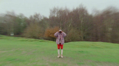 a person standing in a field holding a kite