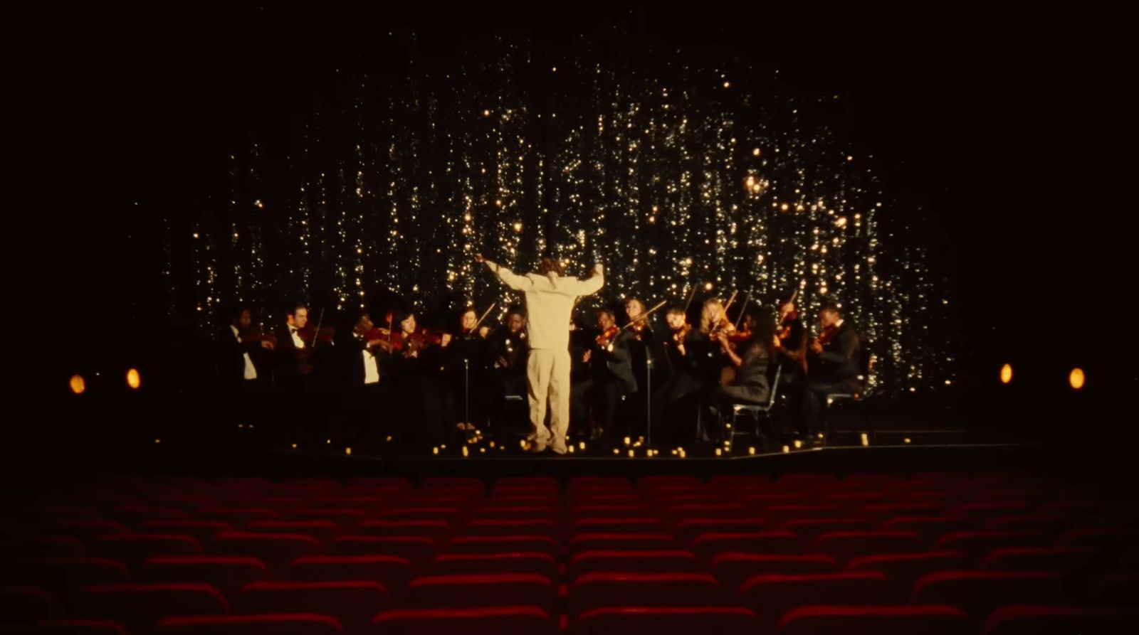 a man standing on top of a stage in front of a crowd