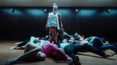 a group of people laying on the ground in a room