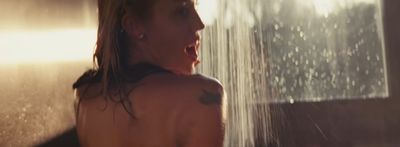 a woman standing in front of a shower head