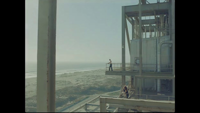 a man standing on top of a tall building next to the ocean