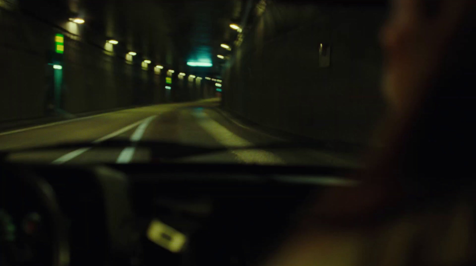 a person driving a car in a tunnel