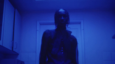 a person standing in a room with a blue light