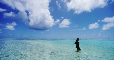 a person standing in the water on a sunny day