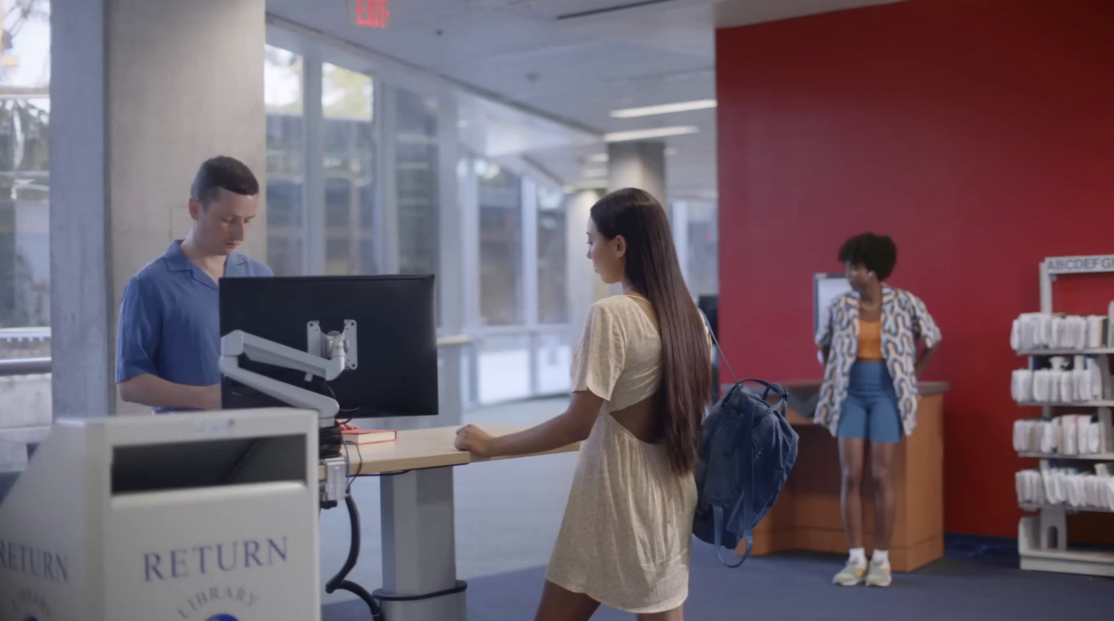 a man and a woman standing at a desk