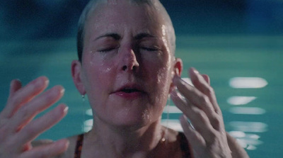 a woman in a swimming pool with her eyes closed