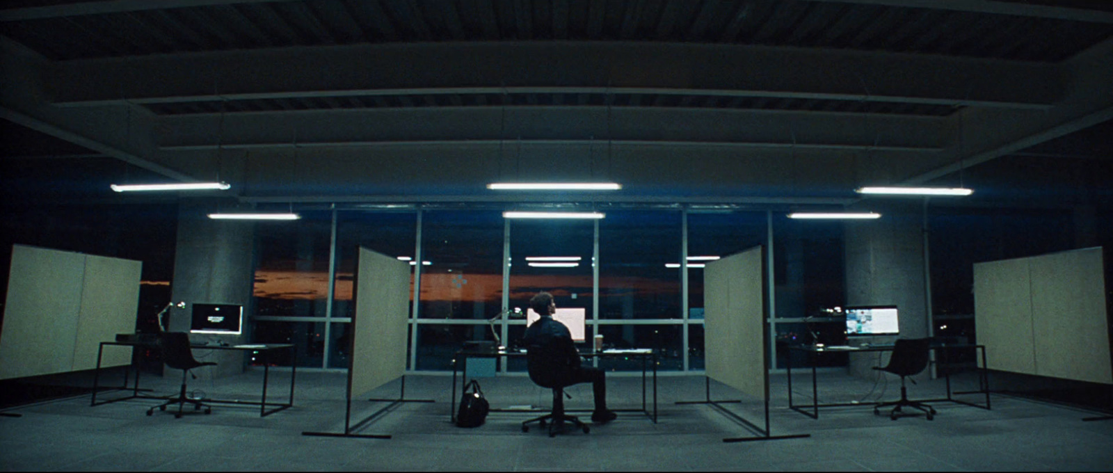 a man sitting in front of a tv in a room