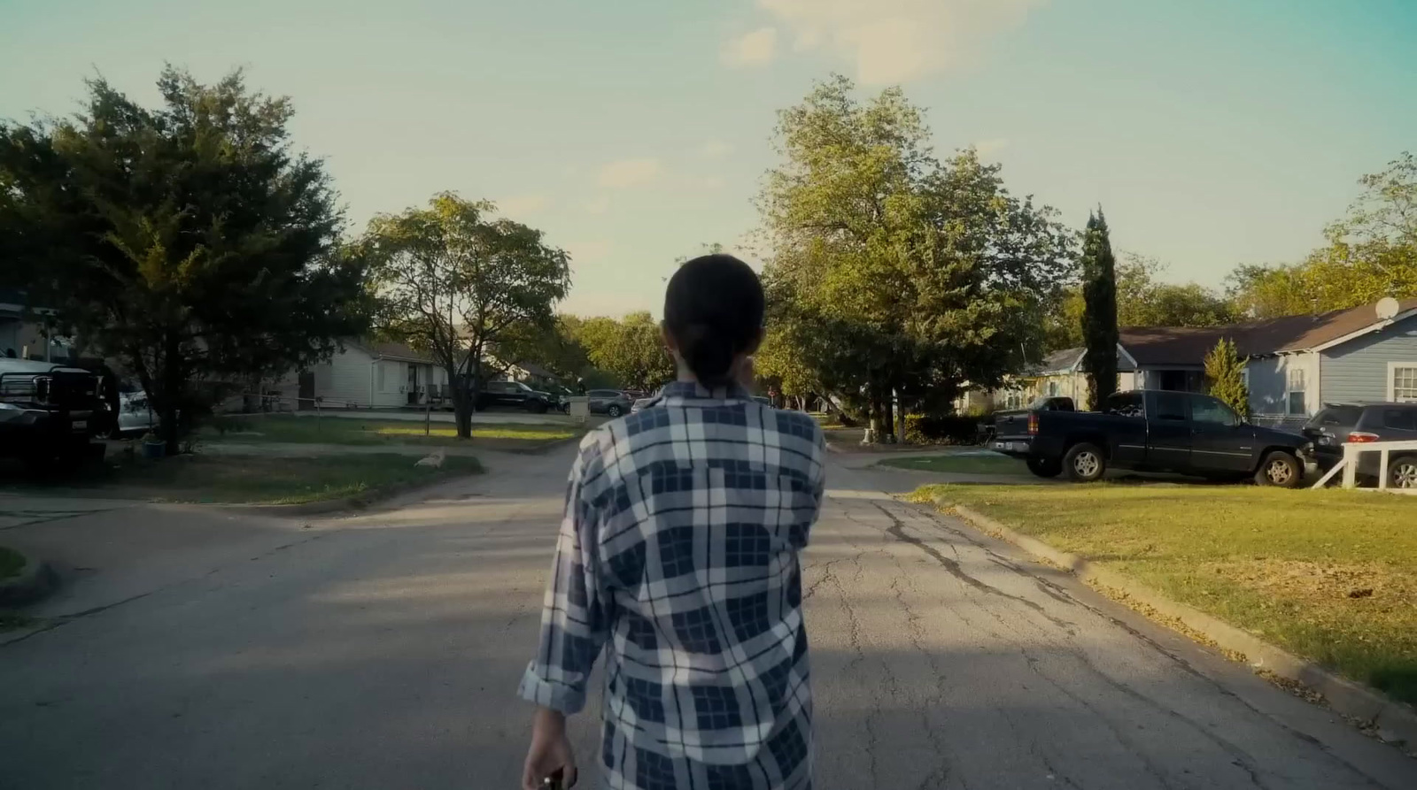 a person walking down a street with a skateboard