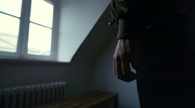 a person standing next to a window in a room