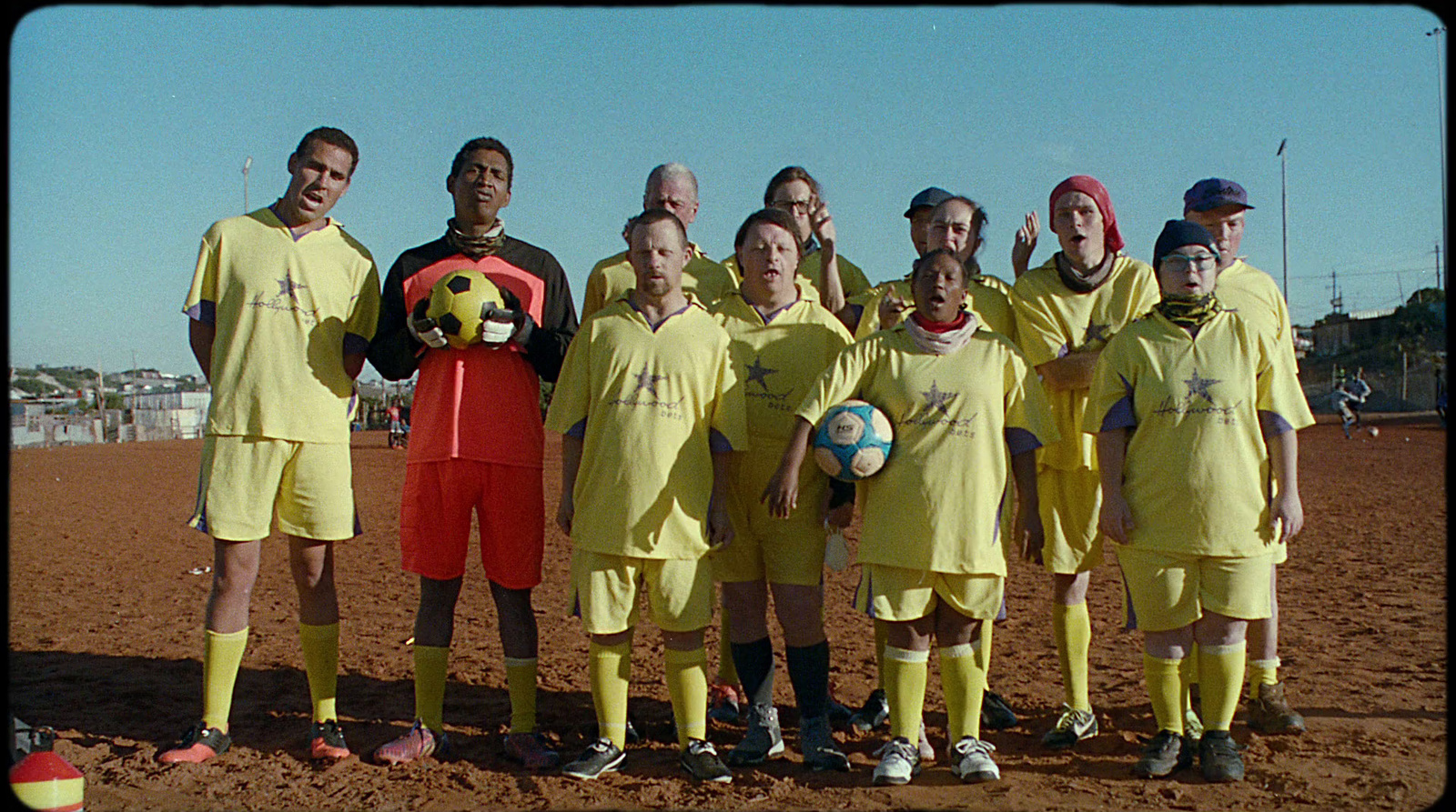 a group of soccer players pose for a picture