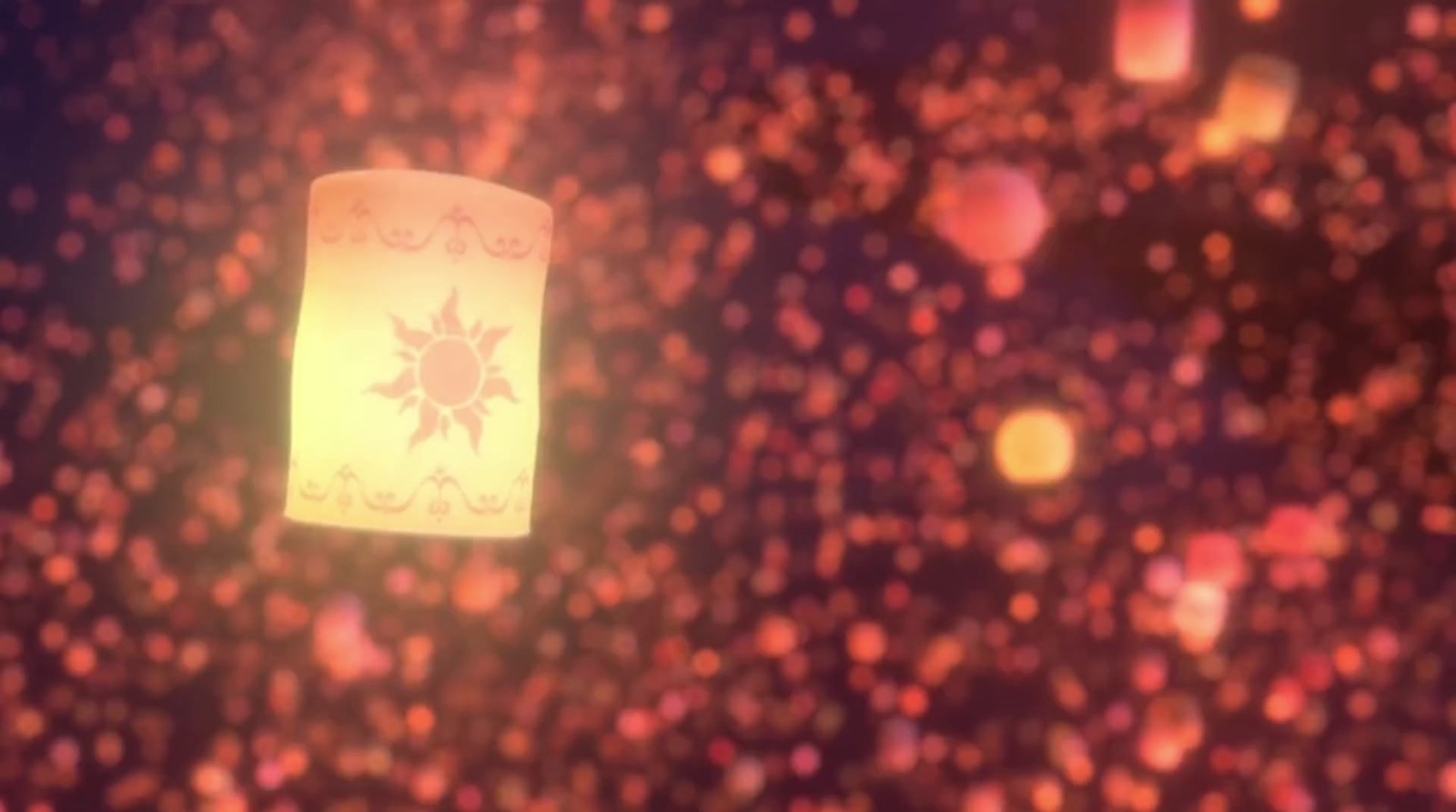 a paper lantern floating in the air on a blurry background