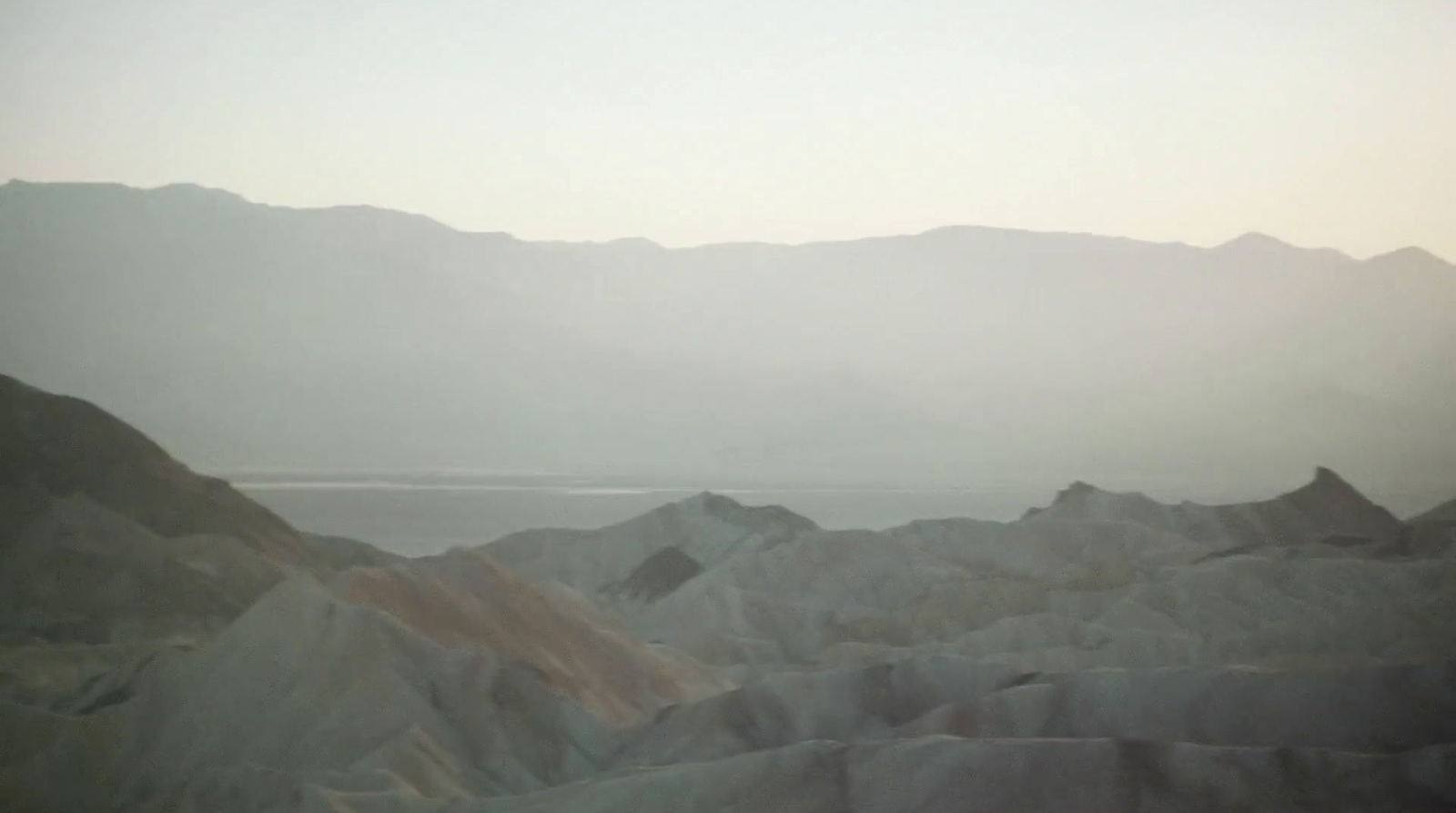 a view of mountains and a body of water