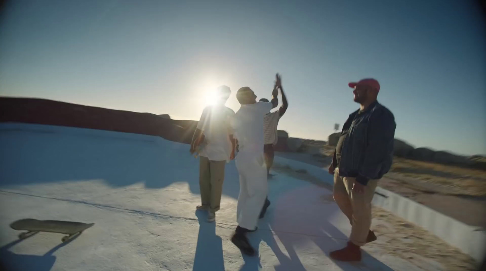 a group of men standing on top of a snow covered slope