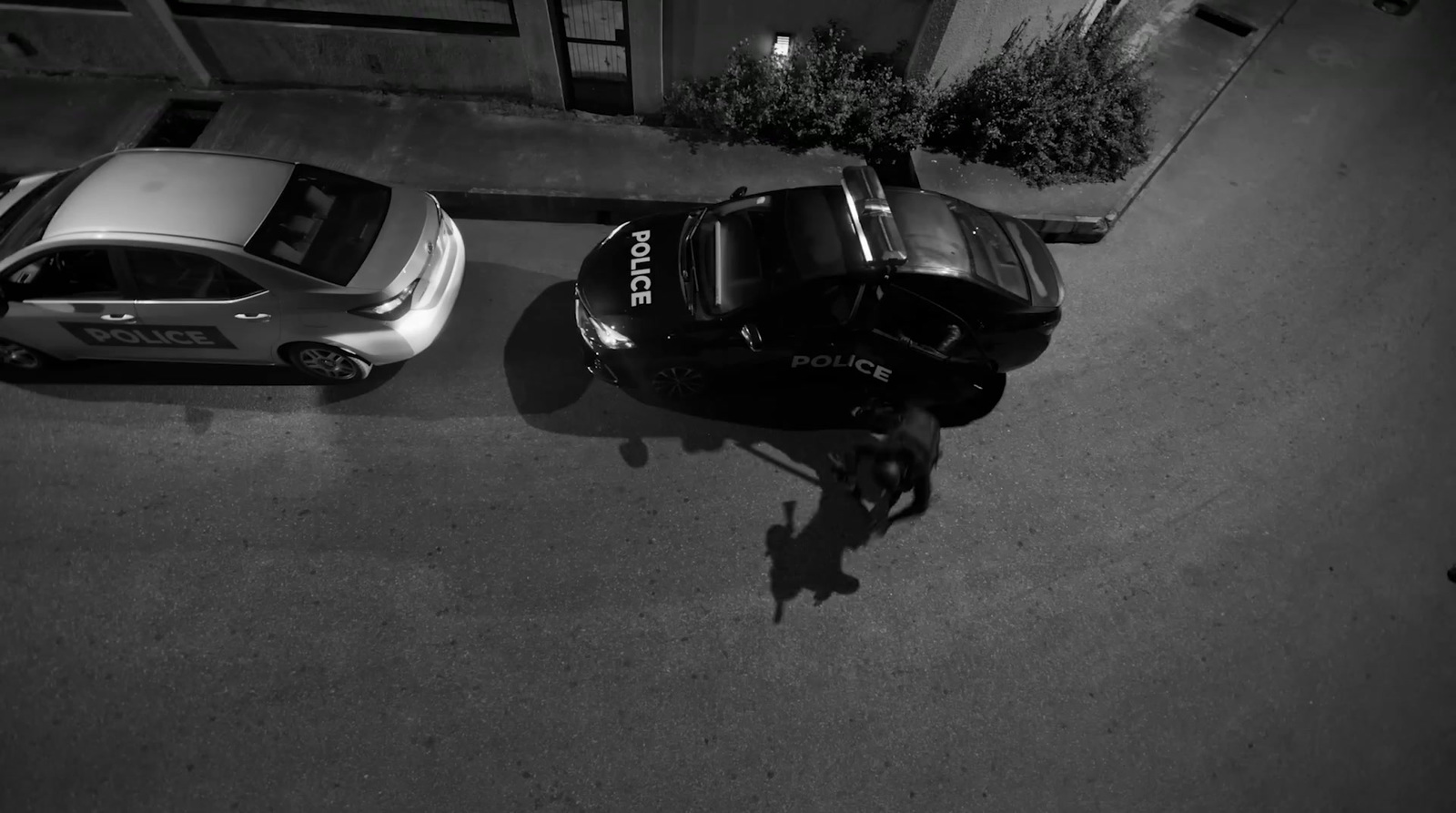 two police cars parked next to each other on a street